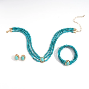 Bohemian multilayer turquoise bead necklace set with gold accents on white background