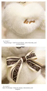 Macro detail of the plush bear's heart embroidery with 'Love You' text and rhinestone bowtie