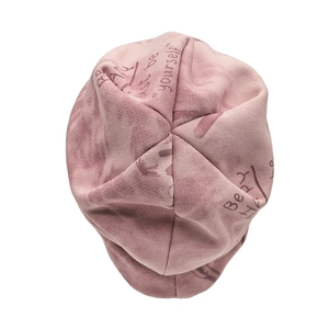 Detailed close-up of pink knit beanie featuring 'Just be yourself' printed text