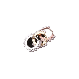 Minimalist silver and rose gold hoop earrings with small pearls on white background