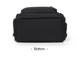 Bottom view of black nylon backpack showing durable fabric texture and compact structure