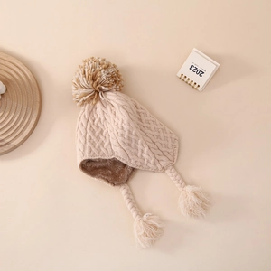 Detailed knit texture and soft fleece lining of this warm baby earflap winter hat