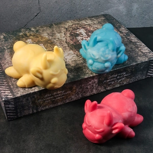 Close-up of cute cow silicone molds in yellow, marbled blue, and pink for DIY crafts