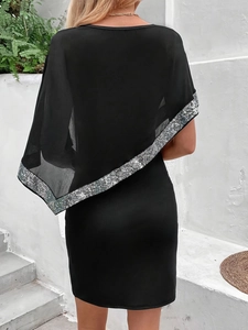 Slim black dress with sheer chiffon sequined cape, back view on a vacation setting