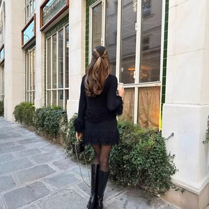 Chic black knitted two-piece set for women featuring elegant fringe trim and midi skirt