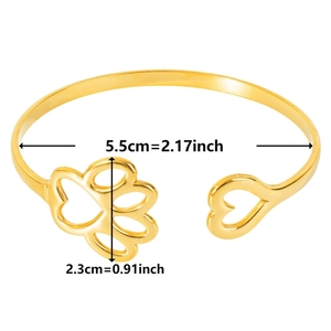 Detailed view of adjustable 18k gold bangle with heart and paw cut-outs and size dimensions