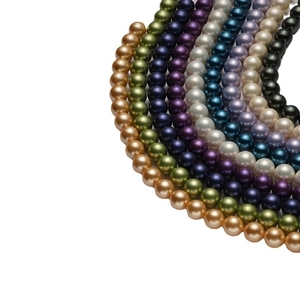 Polished South Sea style colorful synthetic pearls in various metallic shades on white background