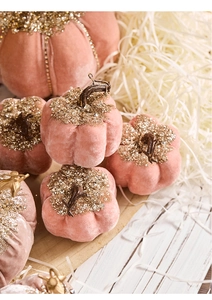 Close-up of pink velvet pumpkin decor with gold sequins and luxury diamond detail