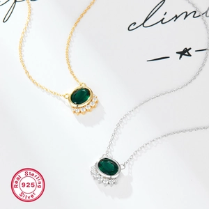 Close-up of 925 sterling silver necklace with oval green zircon and pavé diamond details
