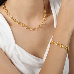 Minimalist gold-plated titanium necklace and bracelet set with spiral geometric design