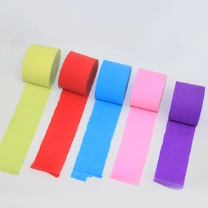 Close-up of multicolored crepe paper rolls with rich pleated texture for party decoration