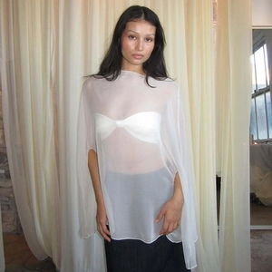 Close-up of a white sheer chiffon poncho top with elegant draped sleeves for women