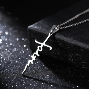 Silver metal cross necklace with faith letter design and bokeh light background