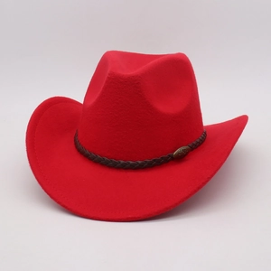Detail of red felt cowboy hat with brown braided leather band and antique bronze emblem
