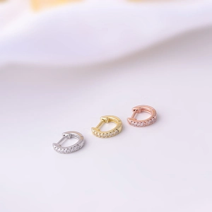 Detailed view of micro-pave zircon hoop earrings in silver, gold, and rose gold finish