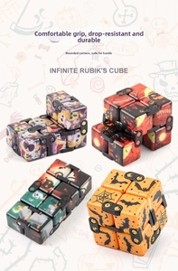 Macro detail of Halloween infinity cubes with pumpkin and ghost patterns for stress relief