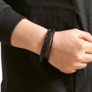 Men's multi-layer bracelet with black leather braid and natural stone beads on a wrist