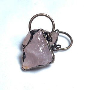 Dettaglio di ciondolo in quarzo rosa con pietra naturale e filo di bronzo fatto a mano