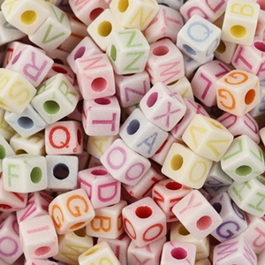 Macro shot of macaron colored square alphabet beads for DIY jewelry bracelets