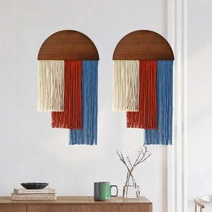 Bohemian woven cotton fringe wall hanging with tri-color tassels on a semi-circular wood base