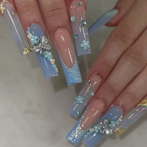 Long coffin nails in light blue and pink with 3D metal butterfly and floral accents