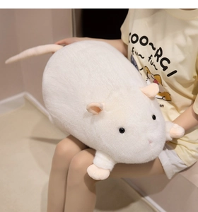 Detail of soft white plush hamster pillow with fluffy fur and pink ears being held