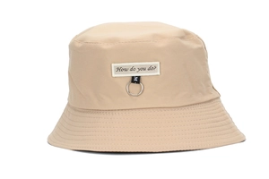 Detail of beige cotton bucket hat featuring 'How do you do?' embroidery and metal ring