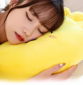 Close-up of a model leaning on a soft, bright yellow plush pillow with cute embroidery