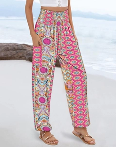 Detail of high-waist bohemian floral print trousers with pockets on beach setting