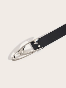 Detail shot of black leather belt featuring a vintage silver rhinestone buckle design