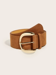 Detailed view of the brown suede wide belt with a polished gold horseshoe metal buckle
