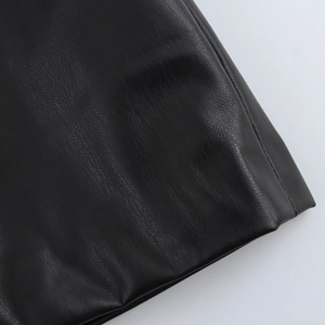 Close-up of black PU leather texture with detailed stitching and lychee grain finish