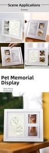 Three-window white commemorative frame for pet paw prints and photos on a wooden desk