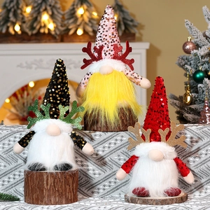 Close-up of festive Christmas gnomes with sequined reindeer antlers on wooden bases