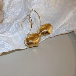 Vintage golden heart earrings with brushed metal texture and elegant hook design