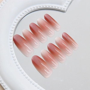 Handmade reddish-brown ombre cat-eye press-on nails in long oval shape with a glossy finish