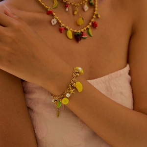18K gold plated stainless steel pearl bracelet with lemon and fruit charms on model