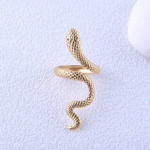 Macro detail of golden snake ring showing intricate scale texture and open adjustable band