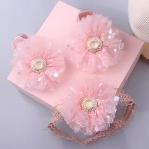 Close-up of pink tulle flower hair accessories set with pearls and sequins for babies