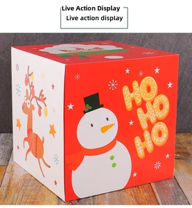 Close-up of a festive red and white Christmas gift box featuring snowman and reindeer