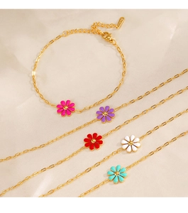 Detail of five colorful enamel daisy charms on gold-plated stainless steel chain bracelets
