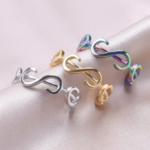 Minimalist stainless steel dollar and music note rings in gold, silver, and rainbow colors
