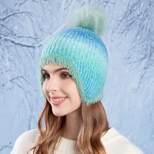 Winter gradient knit beanie with faux fur pompom and ear protection for cold weather