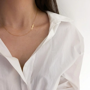 Minimalist 925 sterling silver golden cross choker necklace worn on neck with white shirt