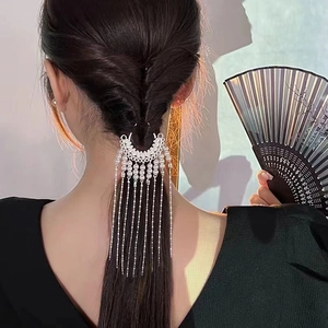 Elegant silver U-shaped hair pin with long pearl tassels on hair bun for women
