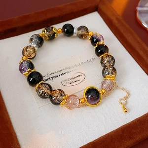 Detail of vintage beaded glass bracelet with gold-tone accents in a premium wooden box