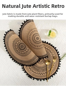 Detailed view of round natural jute placemats with black mandala pattern and tassel edge