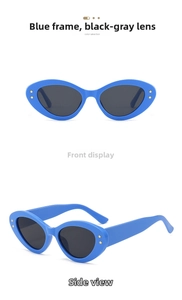 Detail of blue cat-eye sunglasses featuring gold star studs and dark grey lenses