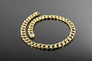 Detailed close-up of 15mm heavy gold Cuban link chain with polished hip-hop metal texture
