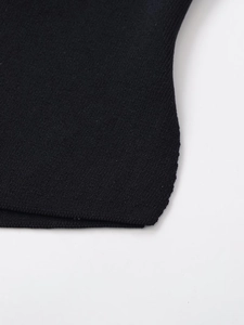 Detailed close-up of stitching on black knitted fabric with a high-quality finish